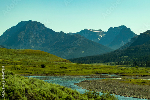 mountain landscape river through a meadow
