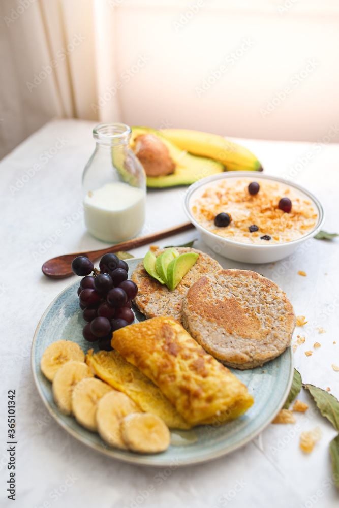 Chia arepa with oatmeal, in a healthy breakfast with egg, milk, cereal, grapes and banana