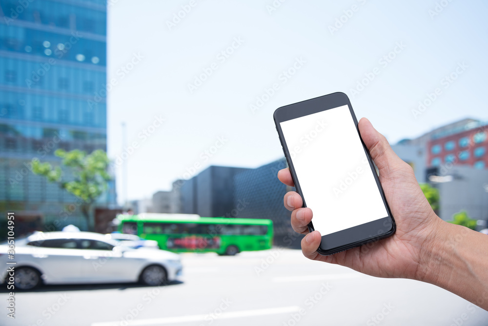 Mockup of man using mobile phone app with traffic on the road background Mockup of man using mobile phone app with traffic on the road background