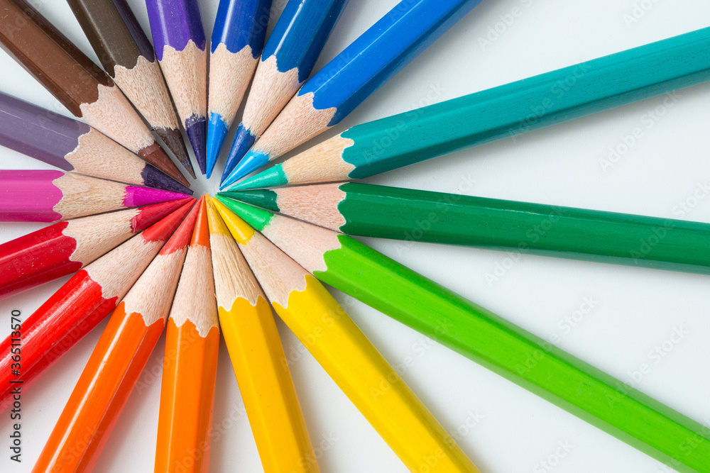 Wheel pattern of  colorful many colored pencils on a white background and copy space