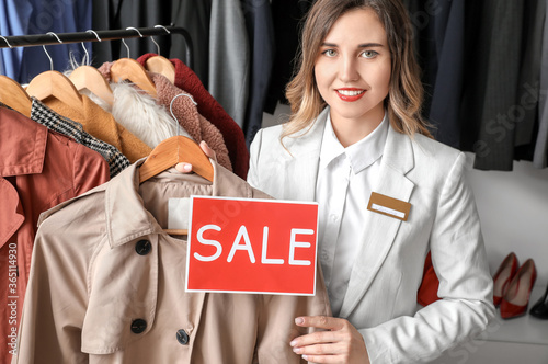 Female seller in modern clo...