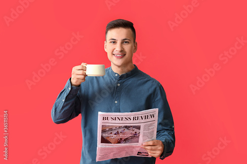 Handsome young man with cup...