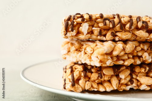 Plate with crispy rice bars on table, closeup