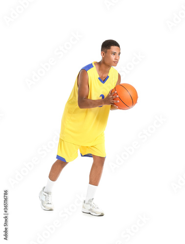 Young African-American basketball player on white background © Pixel-Shot