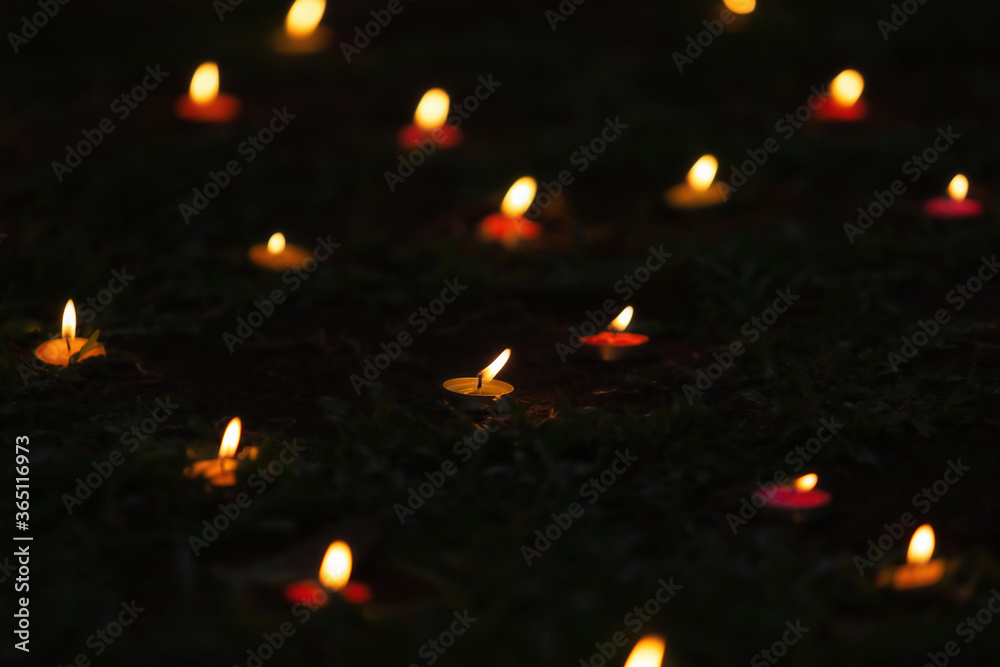 Burning candle on the background in darkness, closeup with space for text. Burning candle on the background in darkness, closeup with space for text.