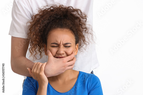 Man covering mouth of Afric...