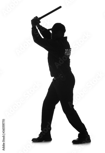 Silhouette of aggressive African-American police officer with baton on white background