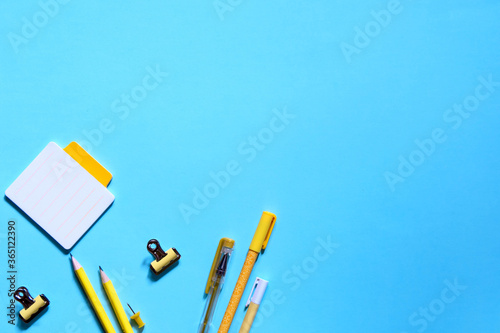 School supplies on blue background. Back to school concept