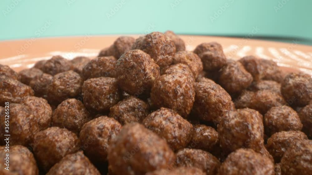 breakfast cereals in the form of chocolate corn balls sprinkle on a plate breakfast cereals in the form of chocolate corn balls sprinkle on a plate