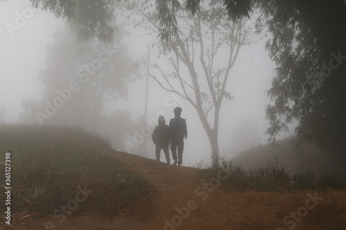 two man in the foggy forest