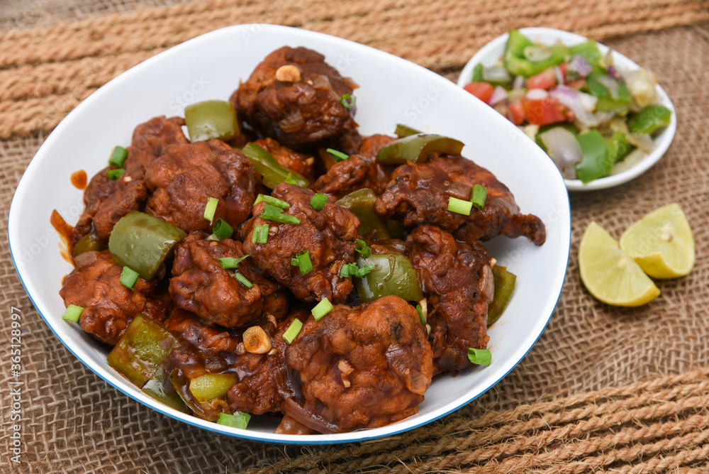 Chicken manchurian,  sweet chilli chicken, red hot and spicy curry Mumbai, Delhi India. Popular North Indian side dish for chapati, roti, naan, paratha, fried rice, pulao. Indo Chinese cuisine. 