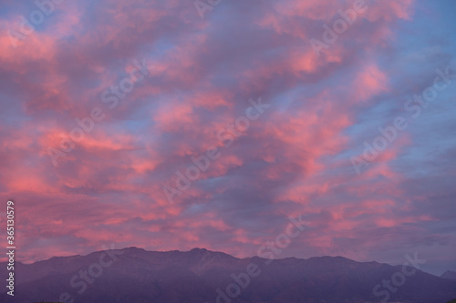 Panorama of amazing purple cloudy sunset sky over Los Andes mountains