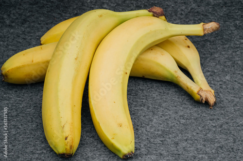 A bunch of bananas isolated on a gray background. Healthy diet. Sport. Dessert.