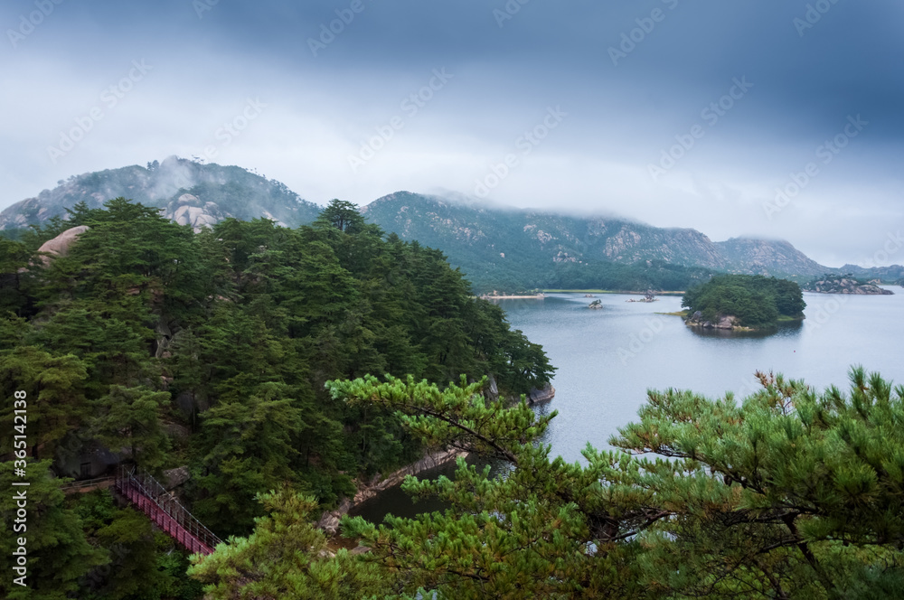Beautiful North Korean landscape of Samilpo lake with dramatic sky on the rainy day