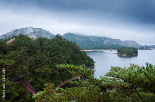 Beautiful North Korean landscape of Samilpo lake with dramatic sky on the rainy day © Lina