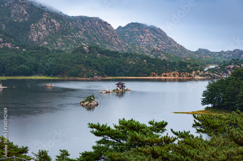 Beautiful North Korean landscape of Samilpo lake with dramatic sky on the rainy day © Lina