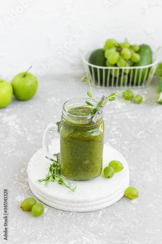 Green vitamin smoothie with shoots of young peas. Green smoothie made from apple, grape and kiwi 