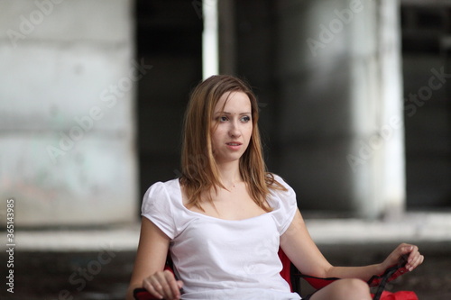 Beautiful young girl in the concrete building at night