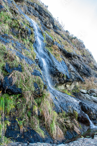 Tarumi Waterfall located between Wajima and Suzu cities, close to Seppun tunnel, falling from 30m cliff to the Sea of Japan on the Sosogi coast of Noto Peninsula, Japan photo