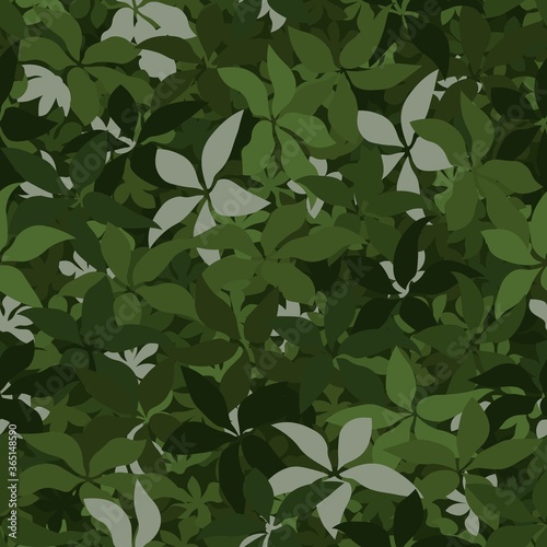 Seamless pattern camouflage texture. The green leaves lying on the ground