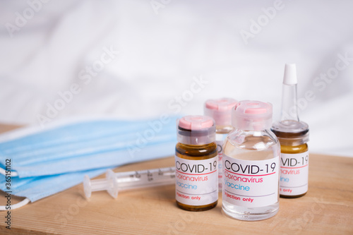 Bottle of coronavirus vaccine on table. Coronavirus vaccine COVID-19.