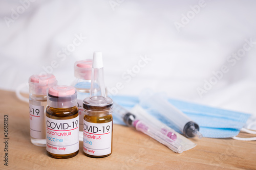 Bottle of coronavirus vaccine on table. Coronavirus vaccine COVID-19.
