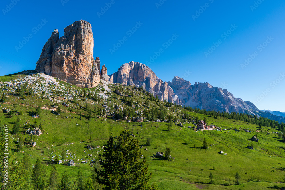 Sunny spring alpine Dolomites rocky mountain scene, Sudtirol, Italy. Cinque Torri (Five pillars or towers) rock famous formation. Picturesque traveling, seasonal, hiking, nature beauty concept scene.