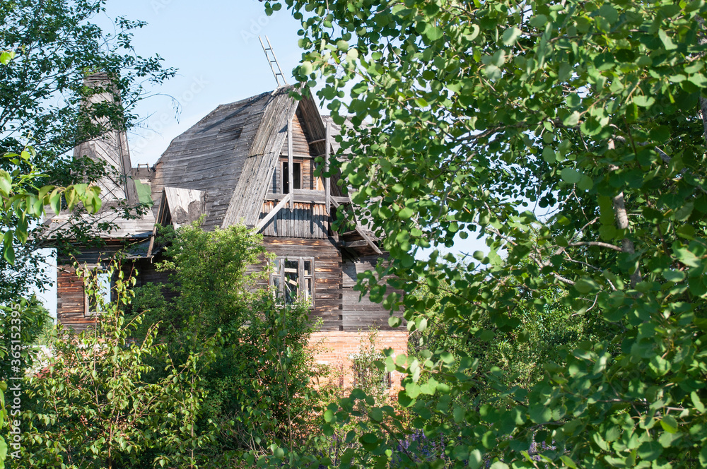 An old, burned-out wooden, dilapidated house An old, burned-out wooden, dilapidated house