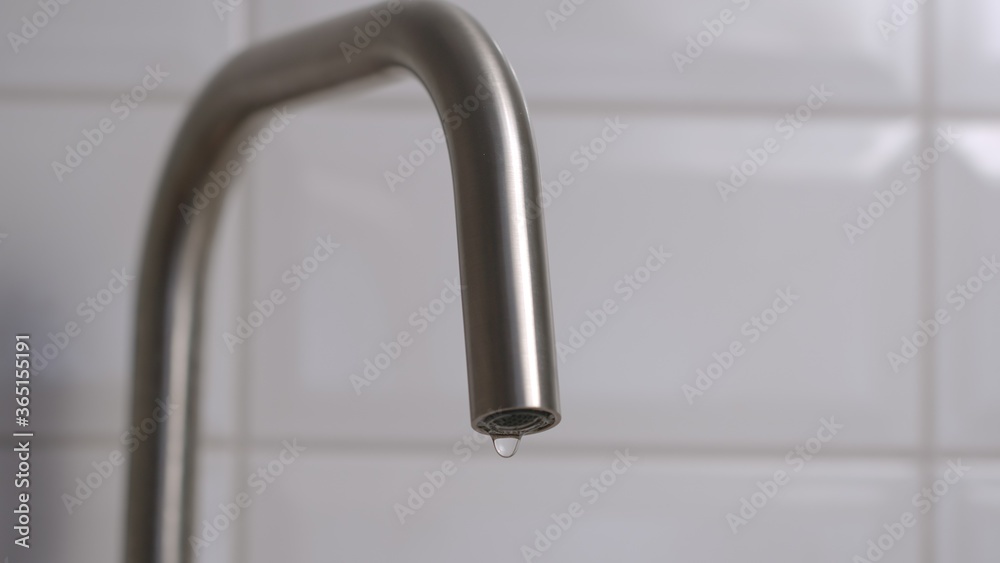 Dripping steel faucet on kitchen Dripping steel faucet on kitchen