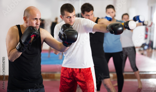 Portrait of mature men sparring in the boxing hall