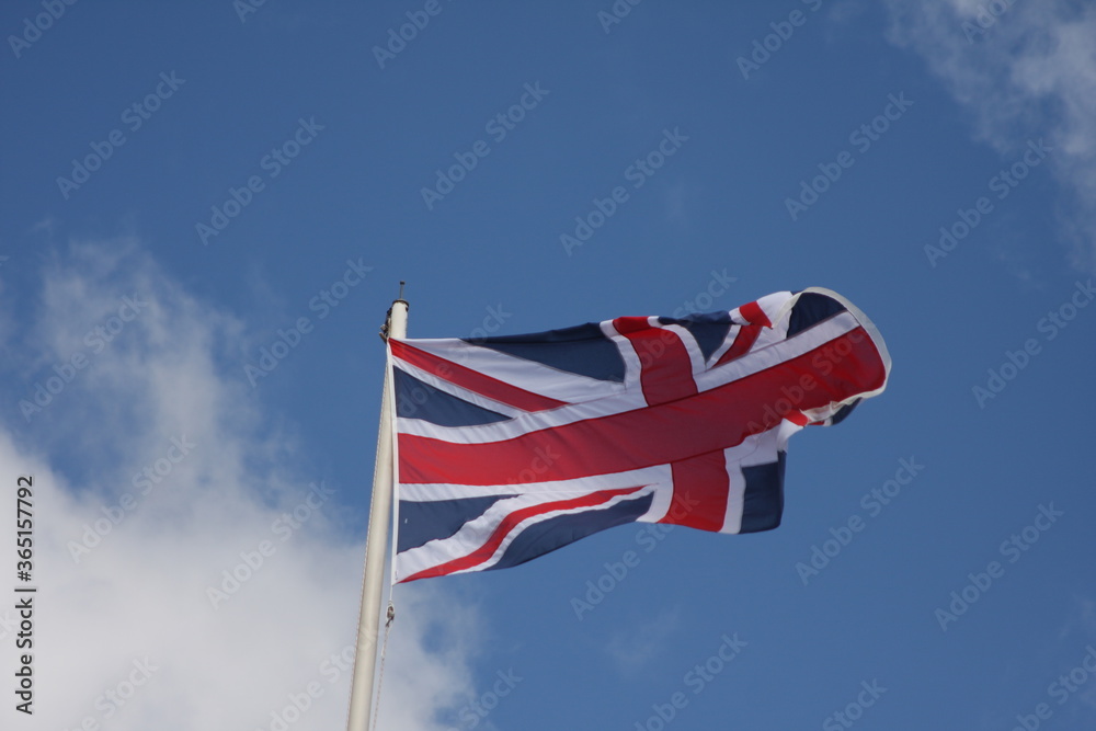 Naklejka premium union jack flag on blue sky