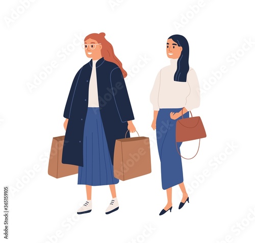 Fashion women shopping together. Modern young customers hold bags, shoppers with purchases dressed in trendy clothes. Sale time in flat cartoon vector illustration isolated on white background