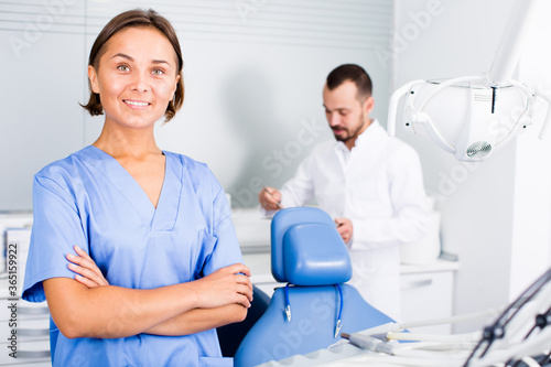 Portrait of dentist and assistant in clinic