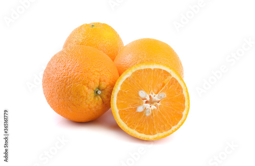 ripe oranges, whole and cut, close-up on a white background, horizontal view