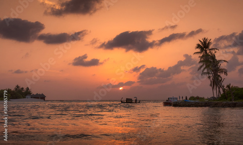 View of traditional Maldivian boat in sunset colors in Huraa island