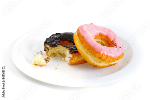 The donut was bitten on a white plate. Isolated on white background