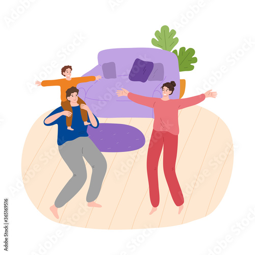 Family with son dancing, enjoying time together and having fun at home