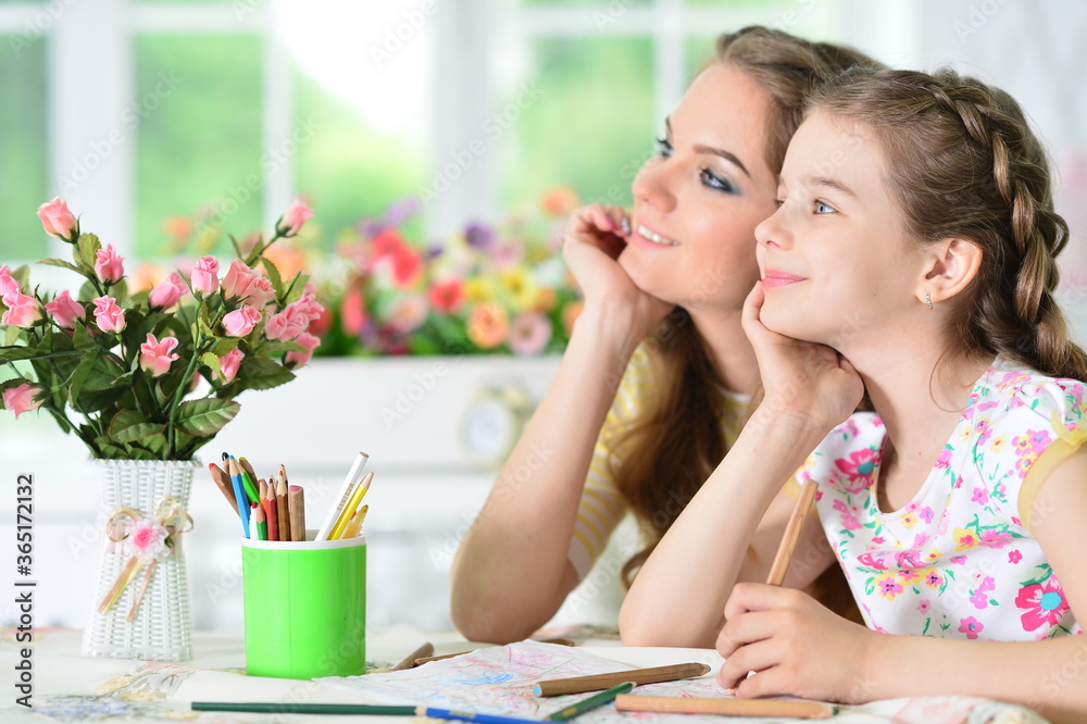 Portrait of girl with mother drawing at home Portrait of girl with mother drawing at home