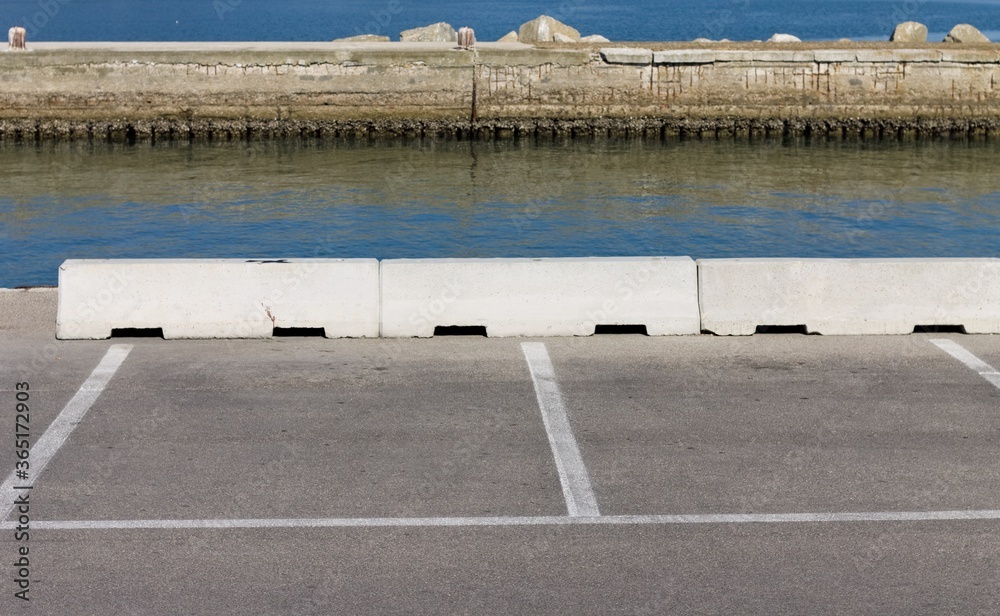 White lines on the asphalt of car park at the harbour (Pesaro, Europe, Italy)