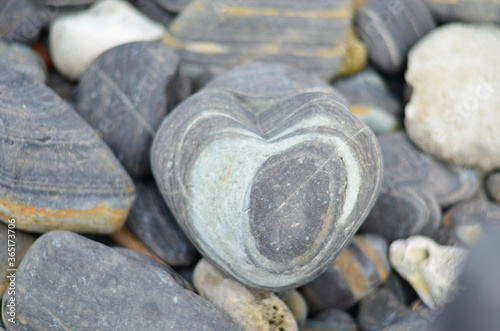 stone heart with rock stones in background. Symbol of love.