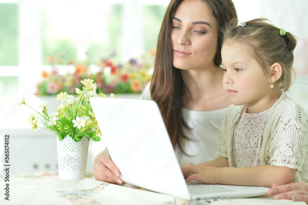 Happy mother and daughter using laptop together Happy mother and daughter using laptop together