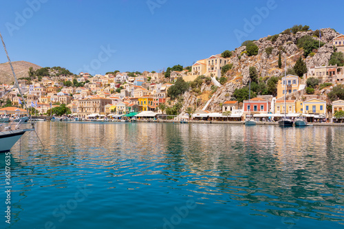 The beautiful island of Symi with a turquoise bay and colorful architecture Dodecanese, Greece © vivoo