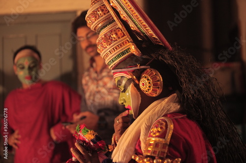 A kathakali dancer applying makeup photo