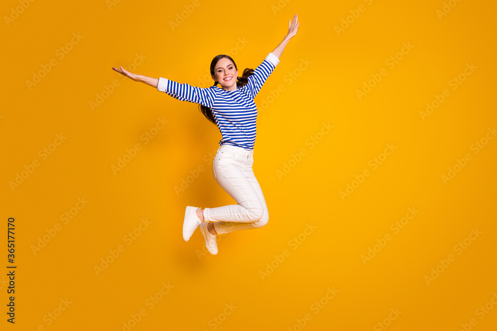 Full size photo of cheerful girl jump hold hand imagine she fly wings plane after spring discounts wear good look clothes isolated over bright color background