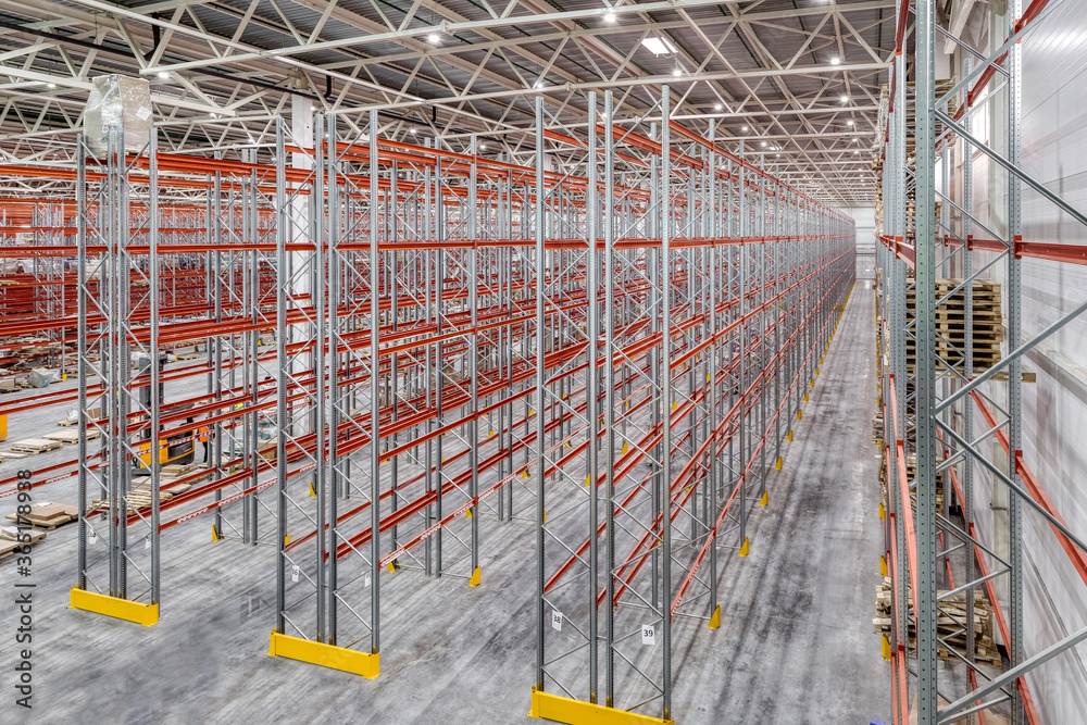 Large warehouse. Tall and long metal shelving.