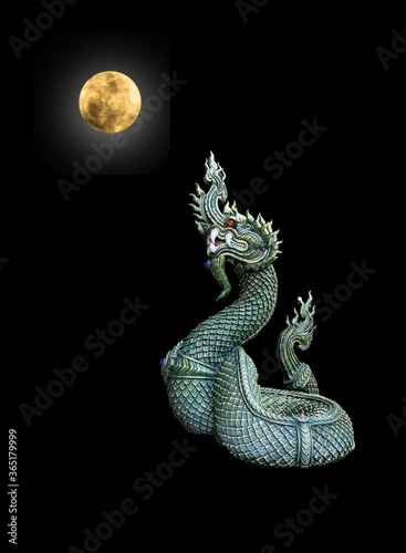 Naga Head the King of Sneak Serpent Statue with fullmoon on black background, Phayanak or naga statue in Thailand