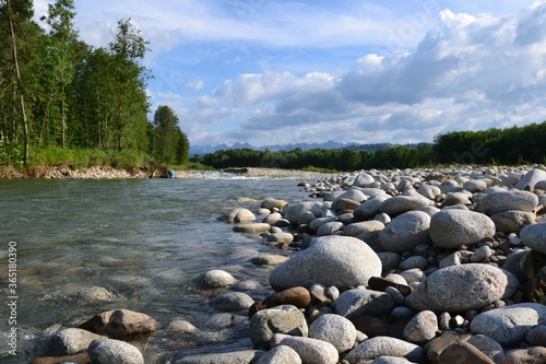 Huge stones on the river bank. View of Bialka mountain river running through southern Poland. It is a tributary of the Dunajec River. Bialka river near Bialka Tatrzanska village, Poland, Europe