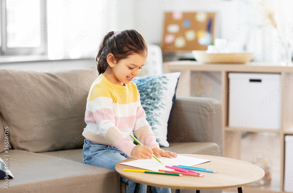 childhood, creativity and art concept - happy smiling little girl drawing with coloring pencils at home childhood, creativity and art concept - happy smiling little girl drawing with coloring pencils at home