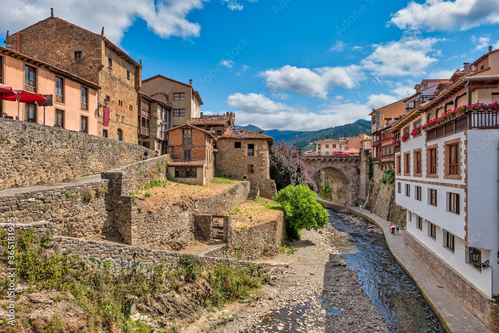 Views of the medieval town of Potes with hanging houses and the Deva river, Cantabria, Spain.