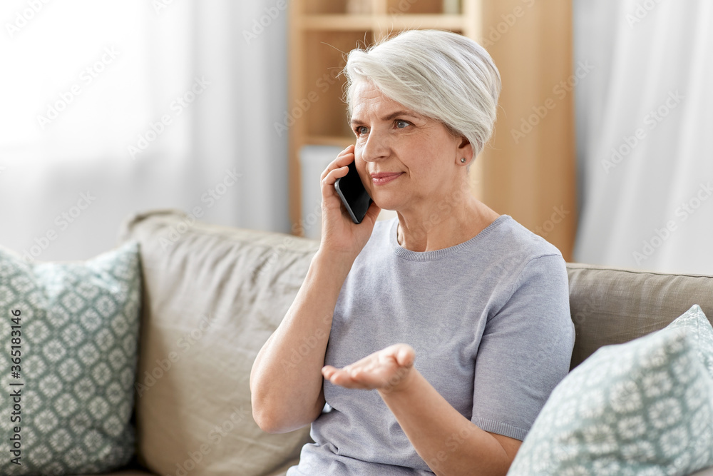 technology, communication and people concept - happy smiling senior woman calling on smartphone at home technology, communication and people concept - happy smiling senior woman calling on smartphone at home